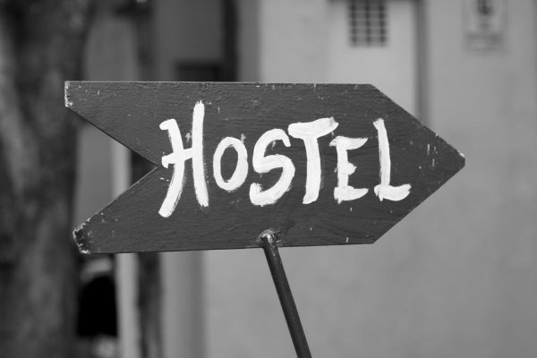 Black and White Pointing Hostel Sign.