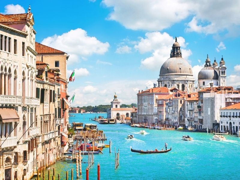 Venice, Italy Is A City Built On The Water. There Are Many Canals With Boats.