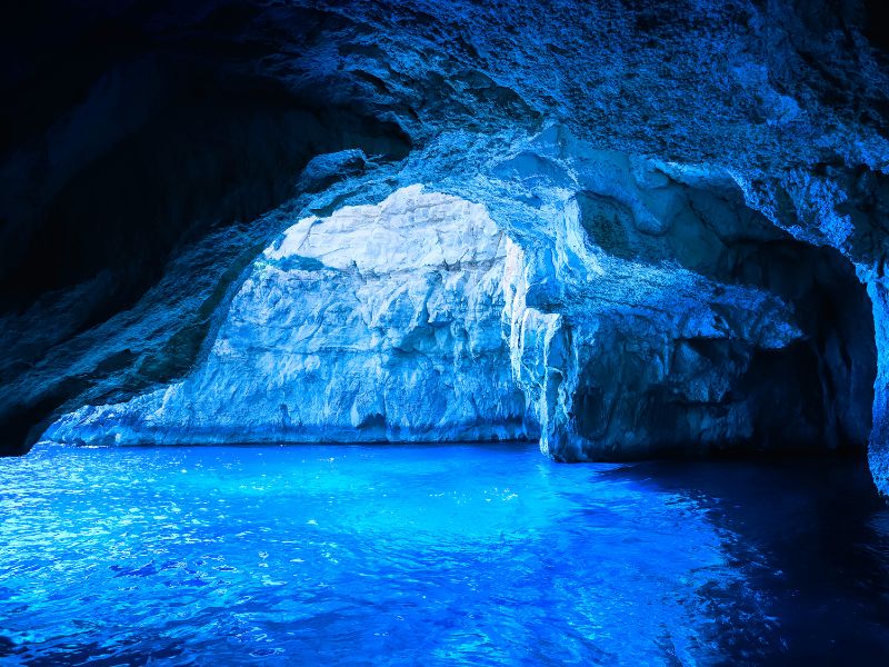 Blue Grotto on the Amalfi Coast is a cave that turns blue from the water sparkling on the cave.