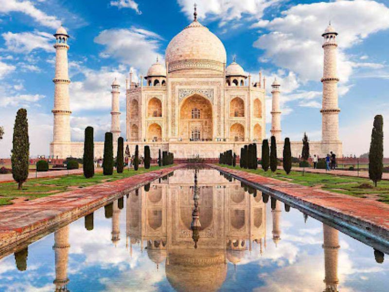 White Taj Mahal reflecting in pond on India's Golden Triangle.