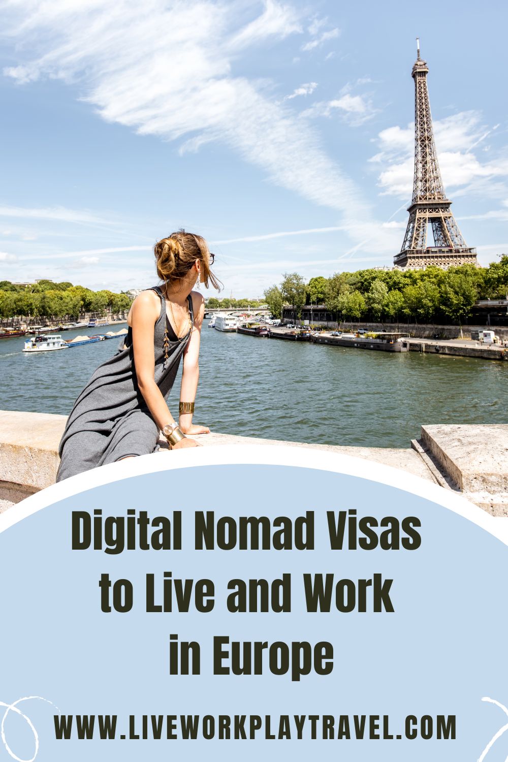 Female in blue dress sitting by The Seine with the Eiffel Tower in the distance.