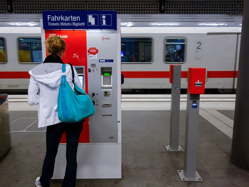 Female buying a ticket for a European train